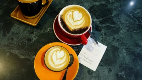 Latte with heart art in a colorful cup.